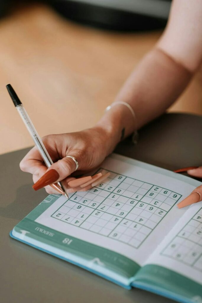 Woman completing hard sudoku puzzle